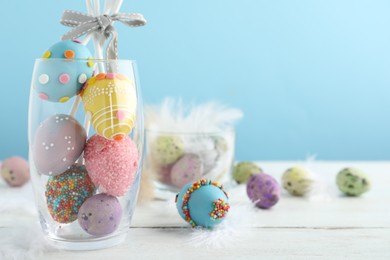 Photo of Delicious sweet cake pops on white wooden table , space for text. Easter holiday