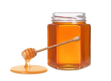 Natural honey dripping from dipper. Jar full of honey on white background