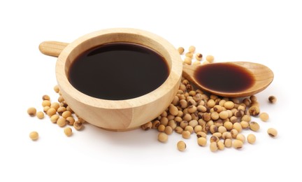 Photo of Tasty soy sauce in bowl, soybeans and spoon isolated on white
