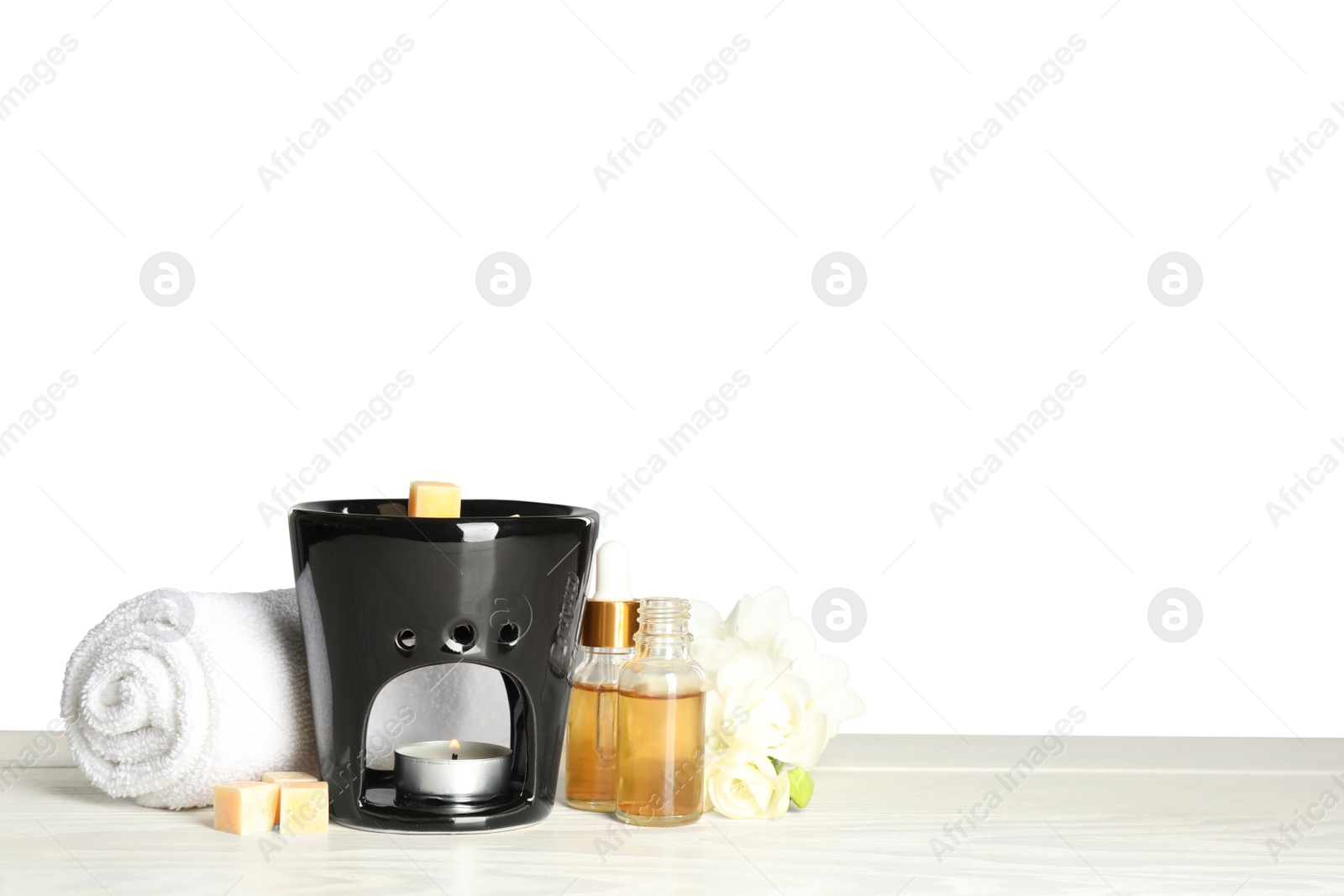 Photo of Composition with aroma lamp on white table against light grey background, space for text