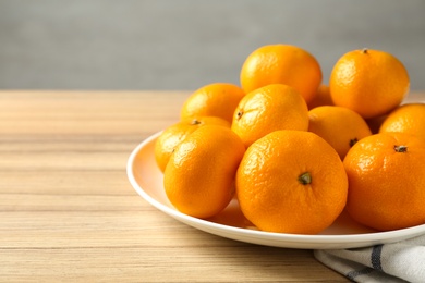 Fresh tangerines on wooden table. Citrus fruit