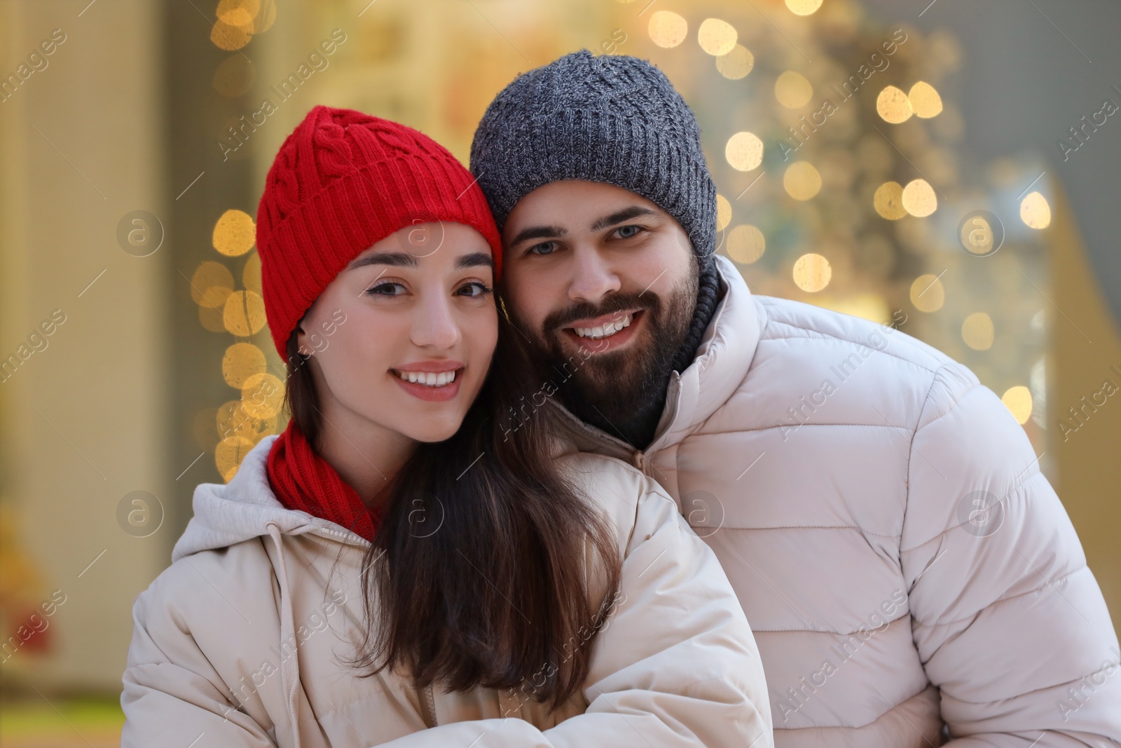 Photo of Portrait of lovely couple outdoors against blurred lights outdoors