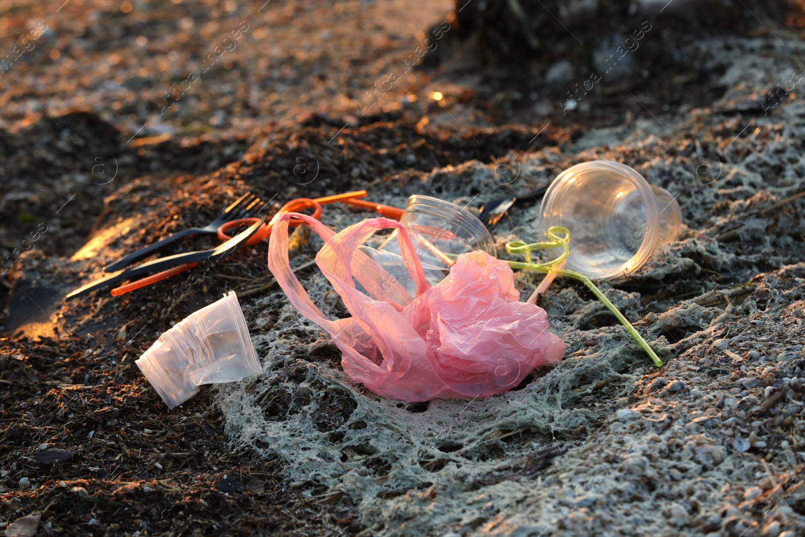 Photo of Plastic garbage at beach, closeup. Environmental pollution concept