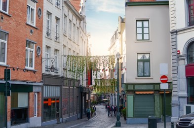 Photo of City street with beautiful buildings on sunny day