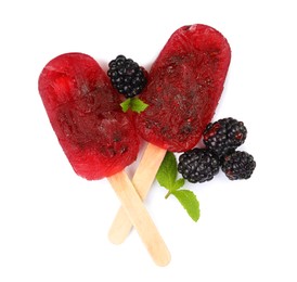 Photo of Delicious ice pops and fresh blackberries on white background, top view. Fruit popsicle