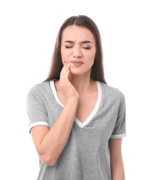Photo of Young woman suffering from tooth ache on white background