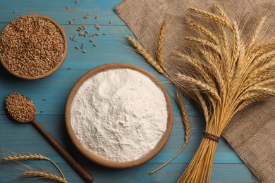 Photo of Flat lay composition with wheat flour on light blue wooden table