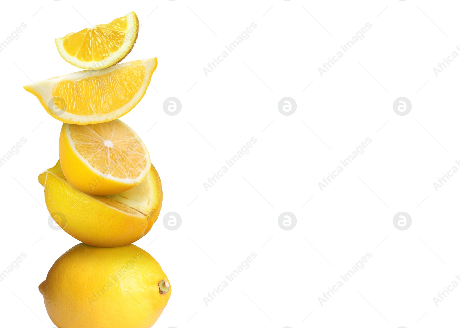 Image of Stacked cut and whole lemons on white background