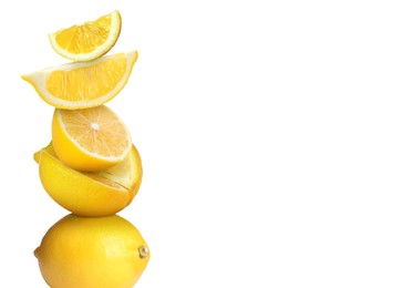 Image of Stacked cut and whole lemons on white background