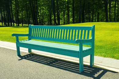 Beautiful view of light blue wooden bench in park