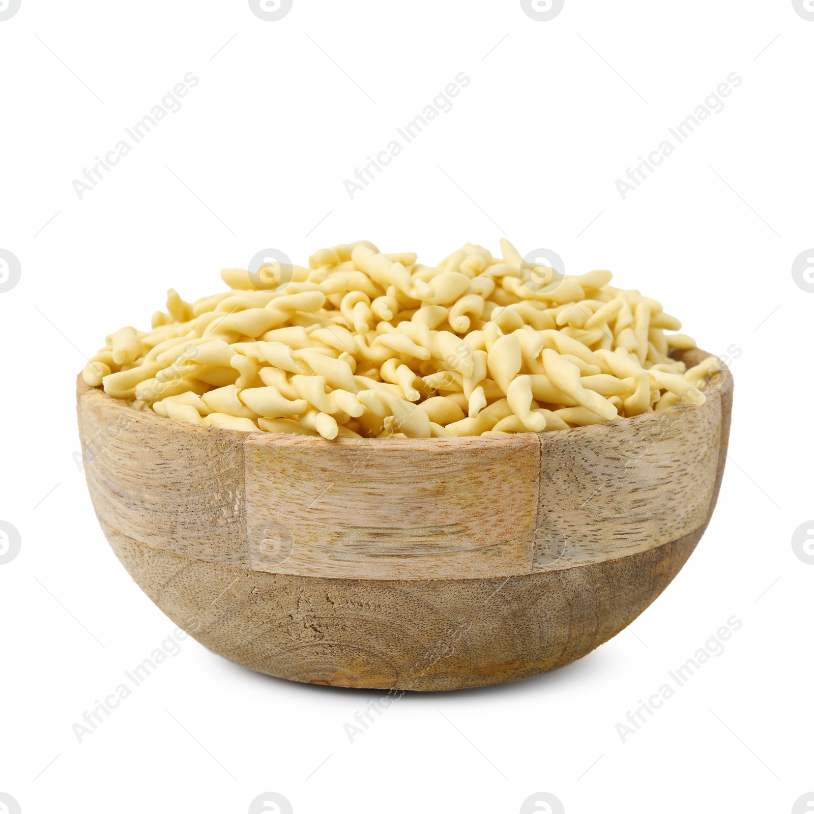 Photo of Uncooked trofie pasta in bowl isolated on white