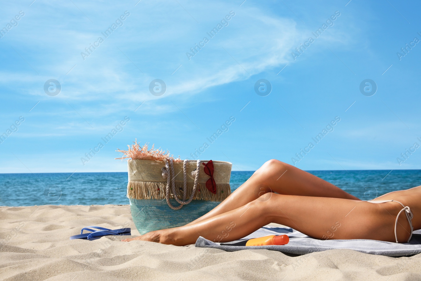 Photo of Woman with beach bag on sand near sea, closeup