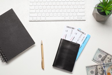 Photo of Flat lay composition with tickets, passport and keyboard on white table. Business trip