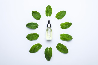 Photo of Bottle of essential oil and mint on white background, flat lay