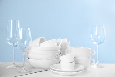 Photo of Set of clean tableware on light table