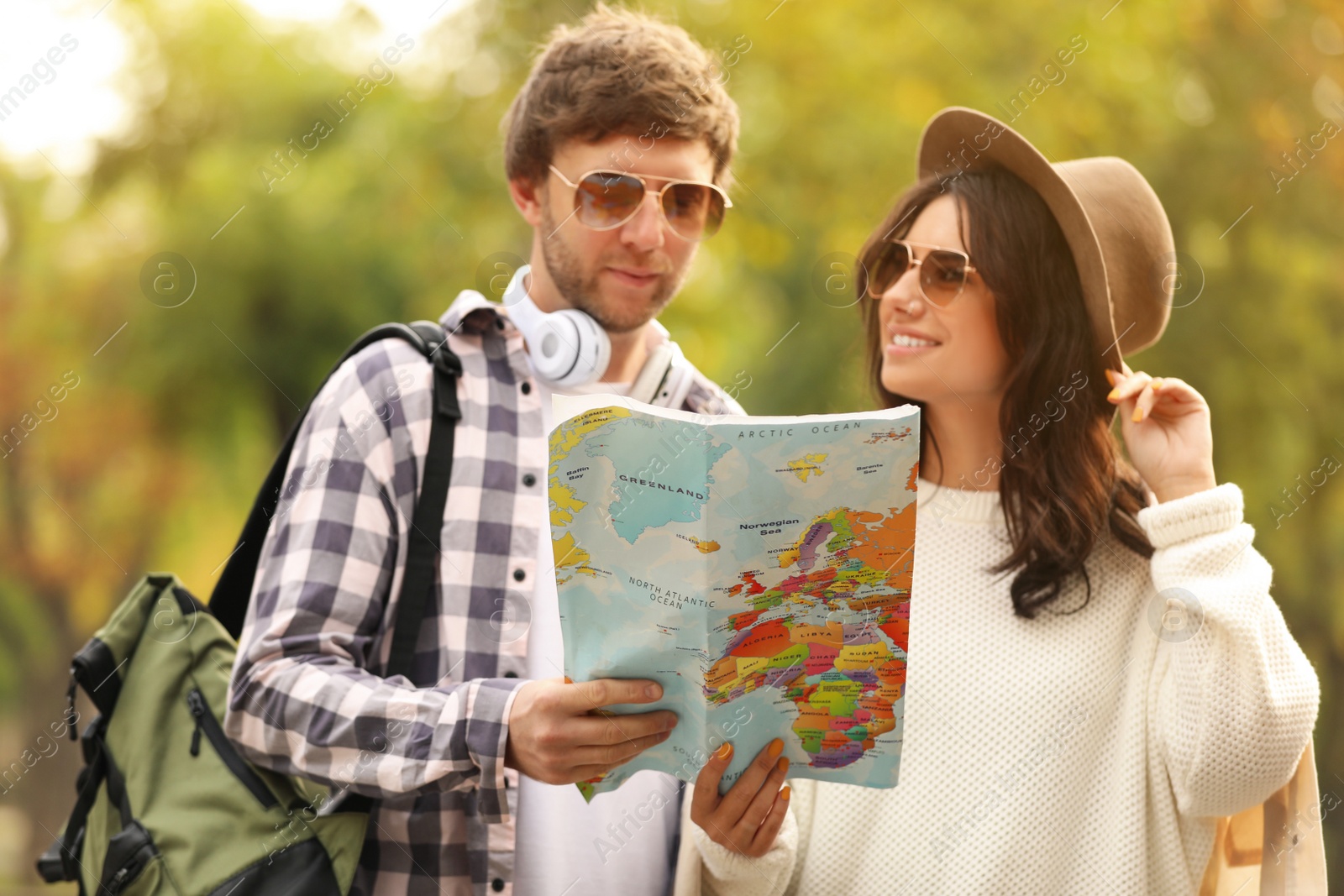 Photo of Couple of travelers with map on city street