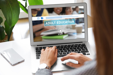 Woman using laptop for online studying indoors, closeup. Adult education 