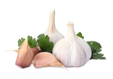 Fresh garlic bulbs and cloves with parsley on white background. Organic food