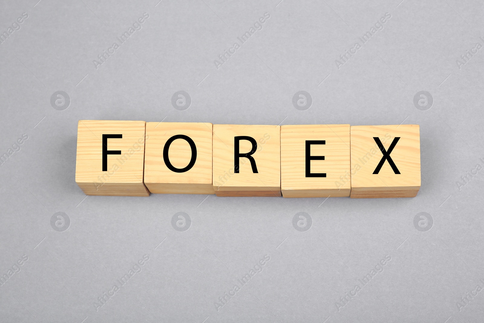 Photo of Word Forex with wooden cubes on grey background, above view