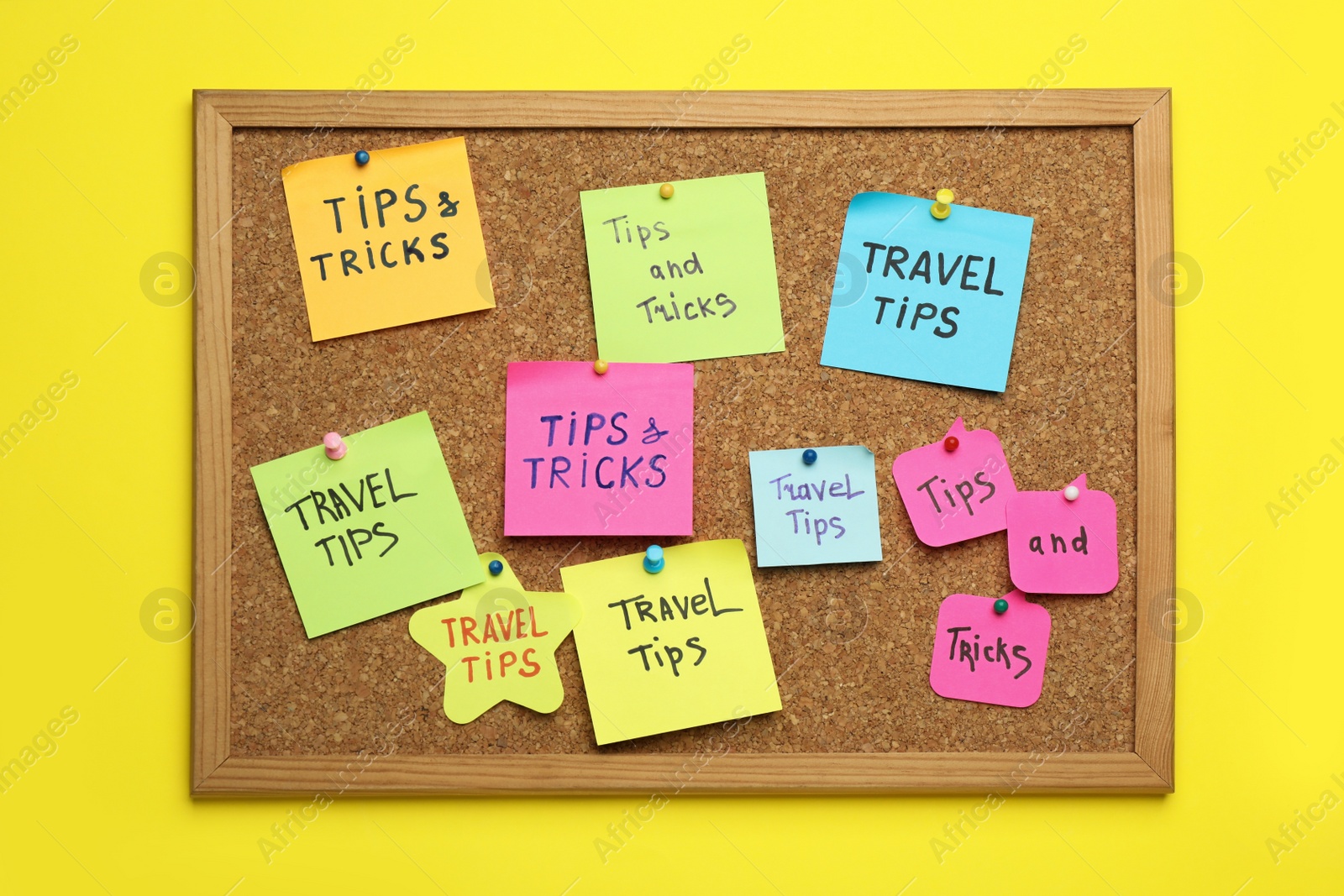 Photo of Colorful paper notes pinned to cork board on yellow wall. Travel tips and tricks