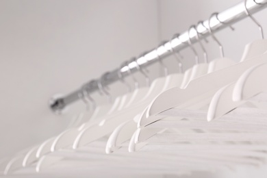 Photo of Clothes rail with hangers in wardrobe