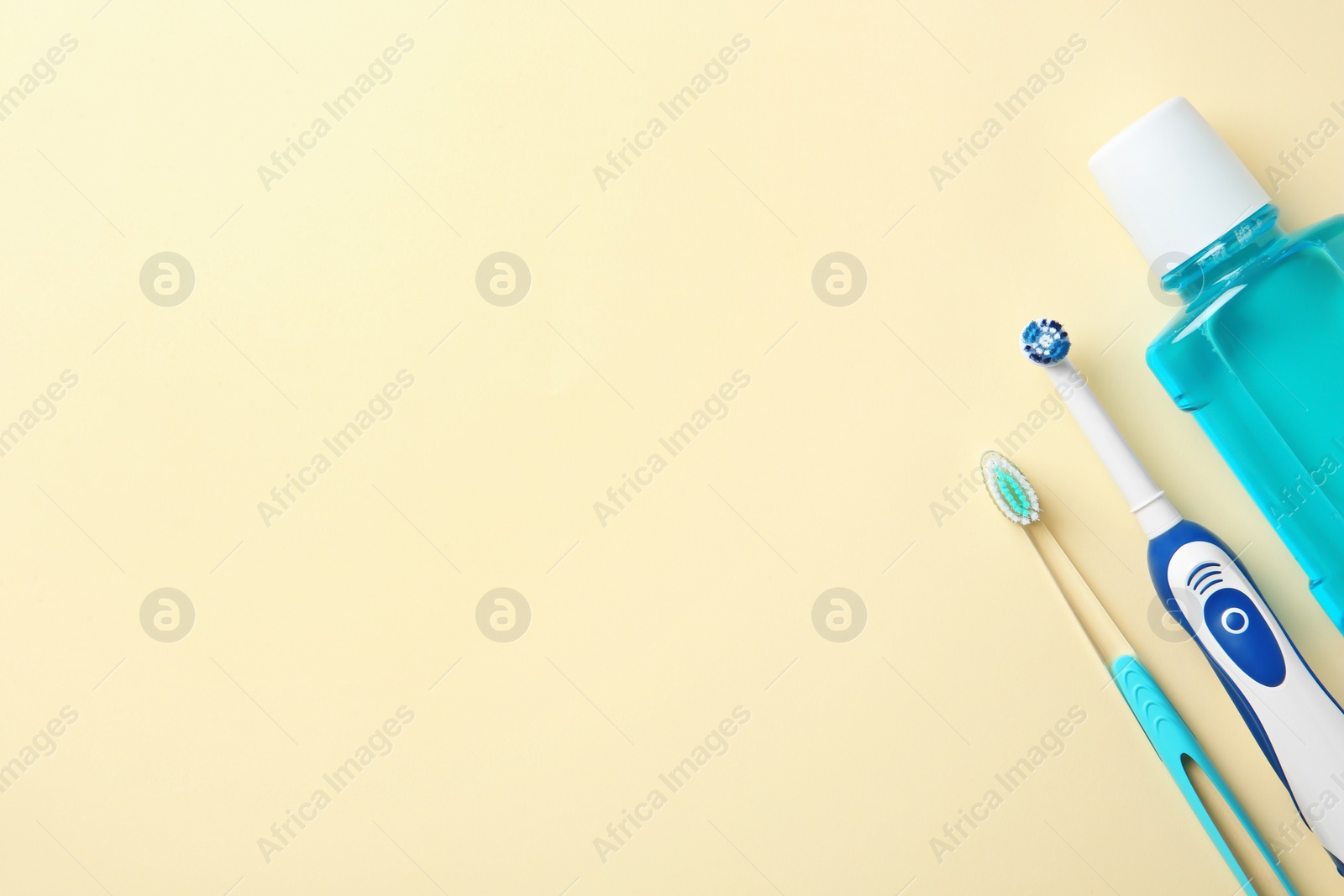 Photo of Flat lay composition with mouthwash, manual and electric toothbrushes on color background