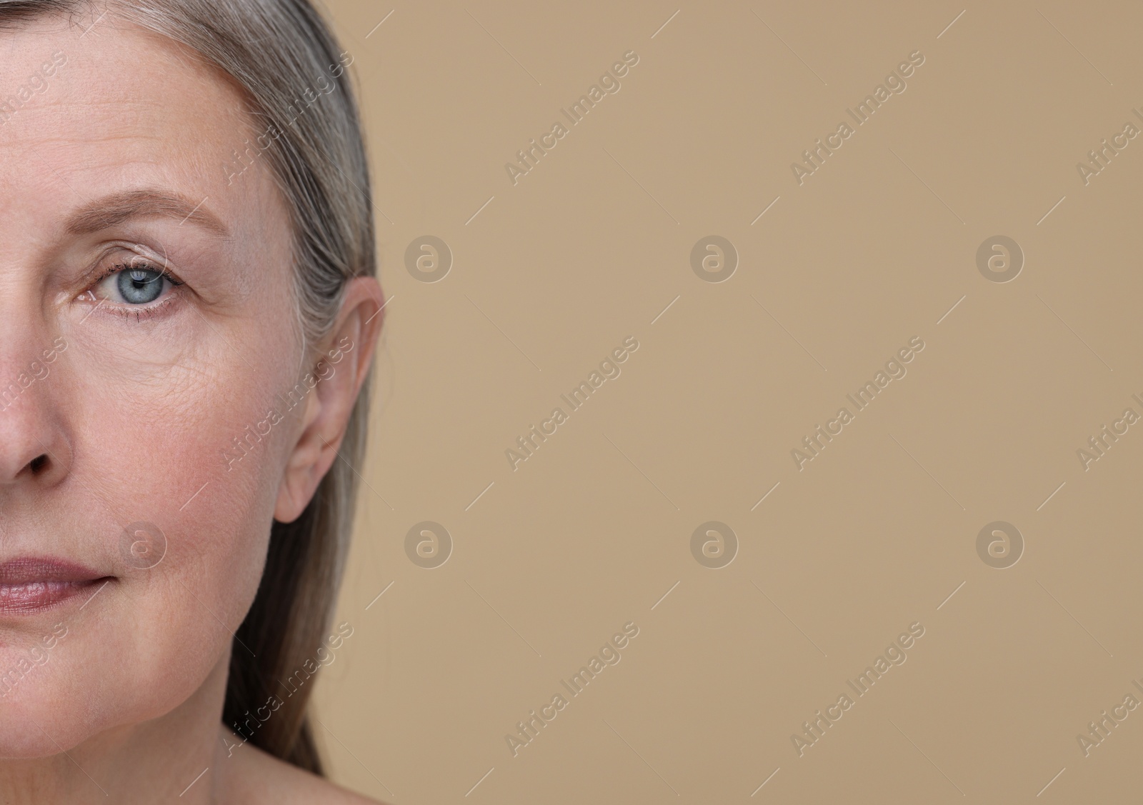 Photo of Senior woman with aging skin on beige background, closeup and space for text. Rejuvenation treatment