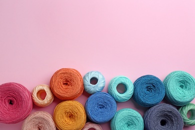 Photo of Clews of knitting threads on color background, flat lay with space for text. Sewing stuff