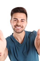 Photo of Portrait of handsome man taking selfie on white background