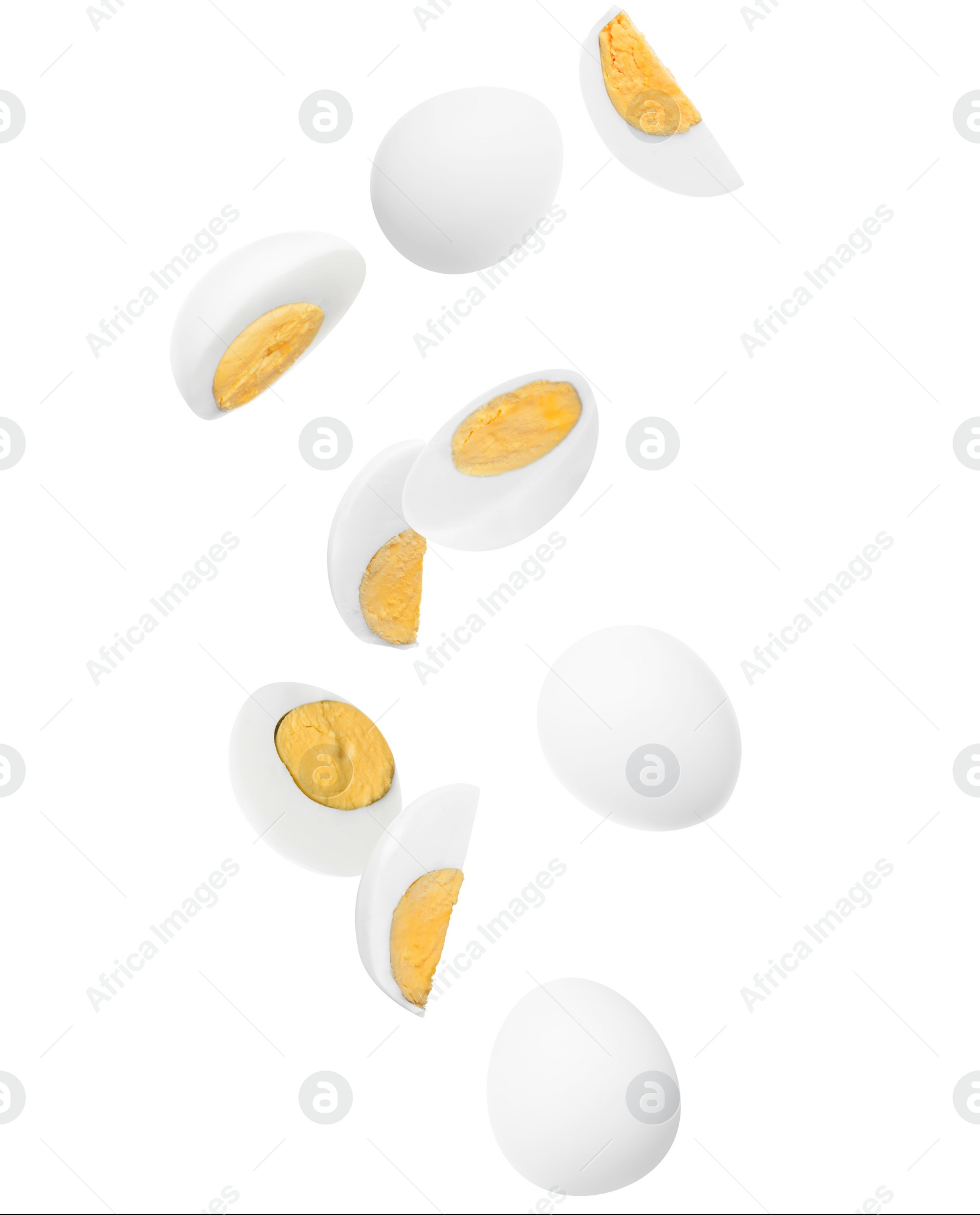 Image of Tasty hard boiled eggs falling on white background