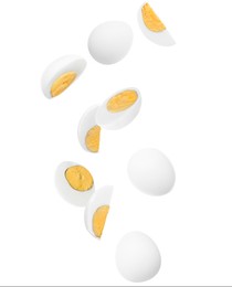 Image of Tasty hard boiled eggs falling on white background