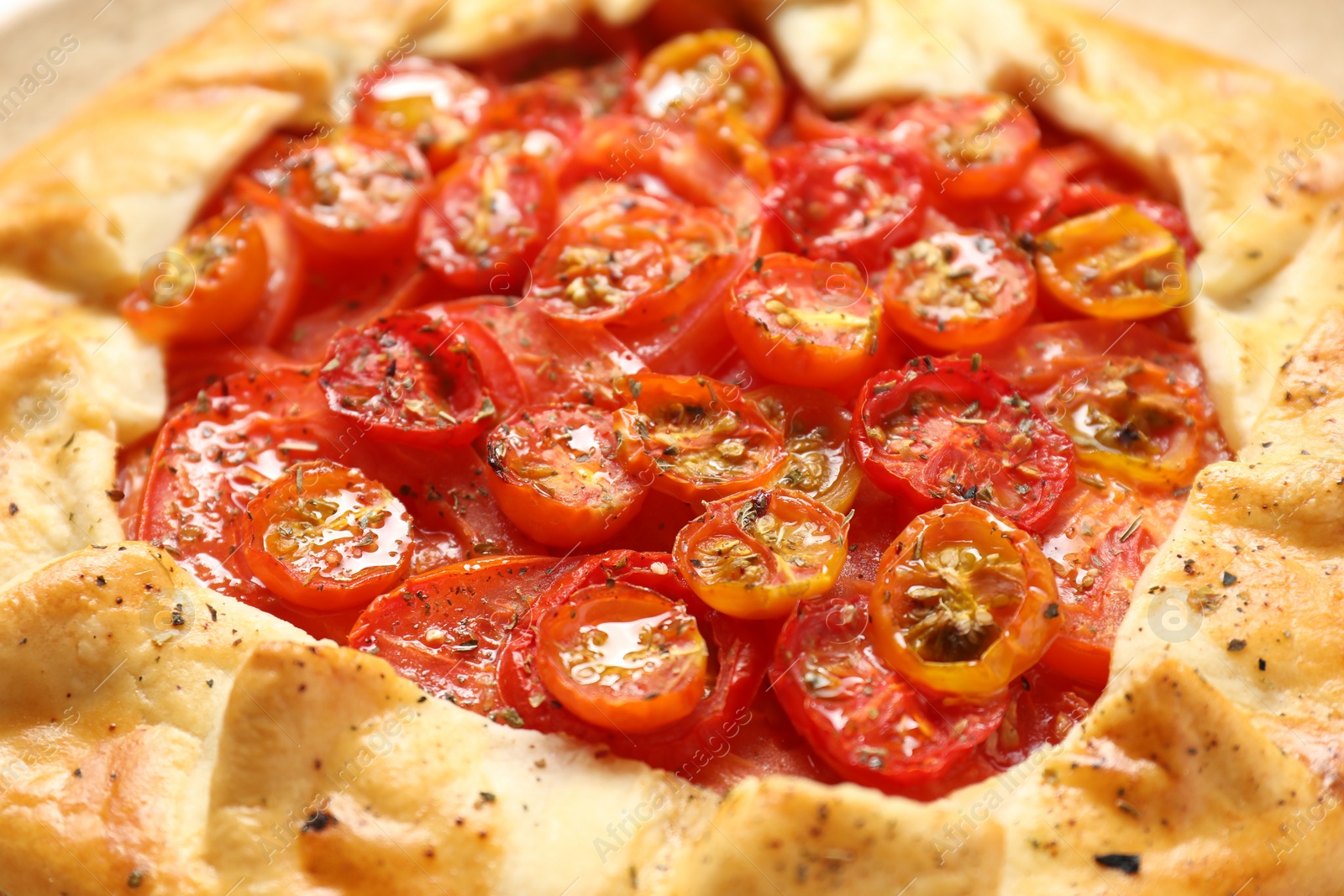 Photo of Tasty tomato galette (Caprese galette) as background, closeup