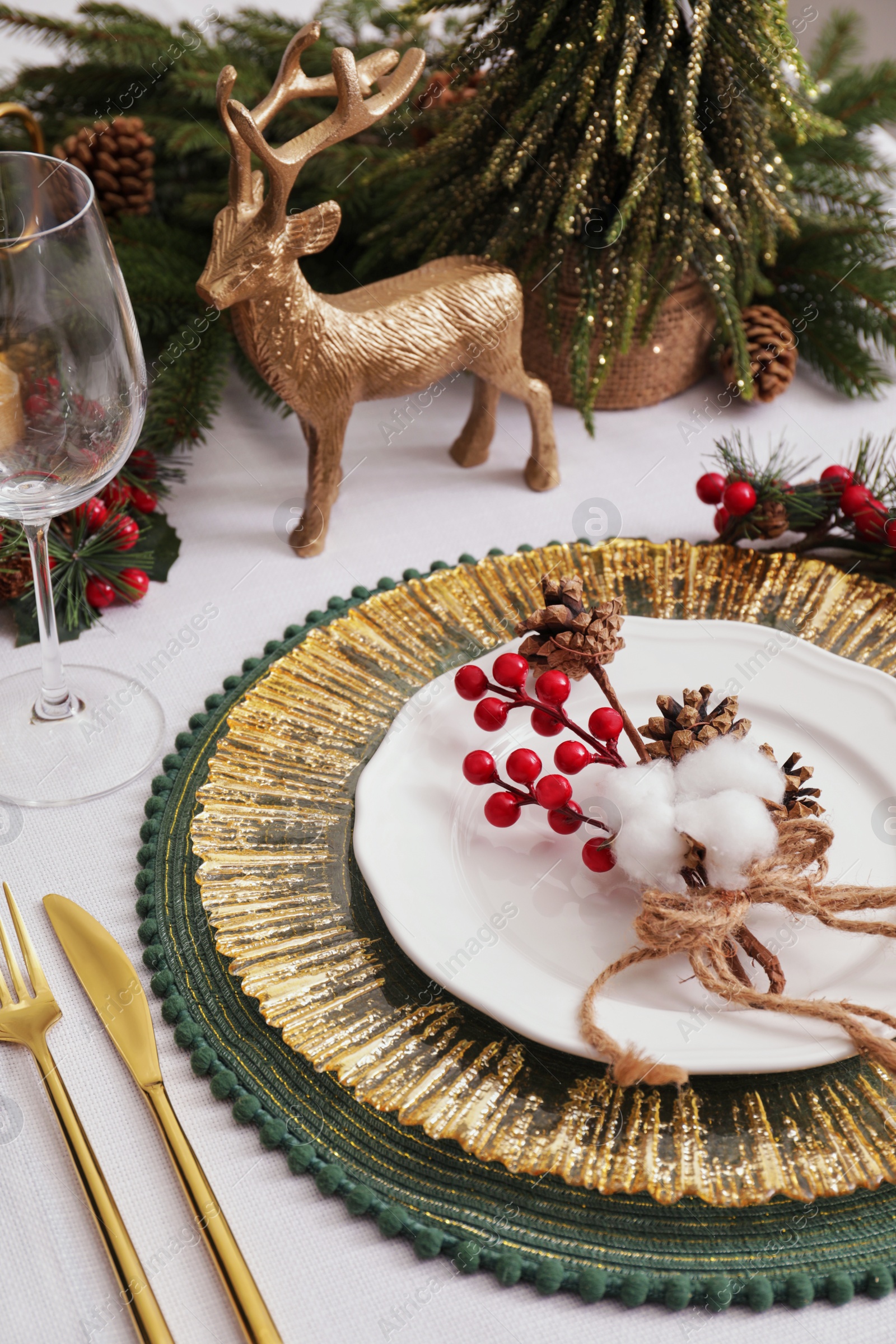 Photo of Luxury festive place setting with beautiful decor for Christmas dinner on white table, closeup