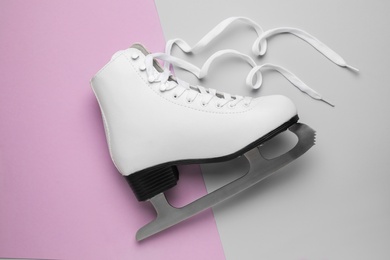 Photo of Figure ice skate on color background, top view