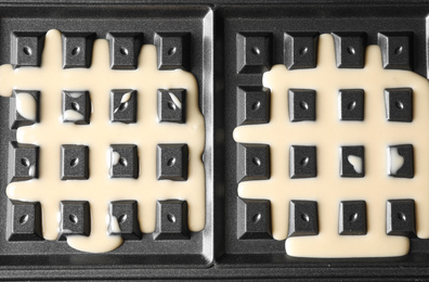 Belgian waffle maker with dough, top view