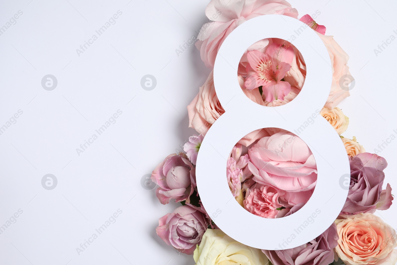 Photo of 8 March greeting card design with flowers on white background, top view. Happy International Women's Day