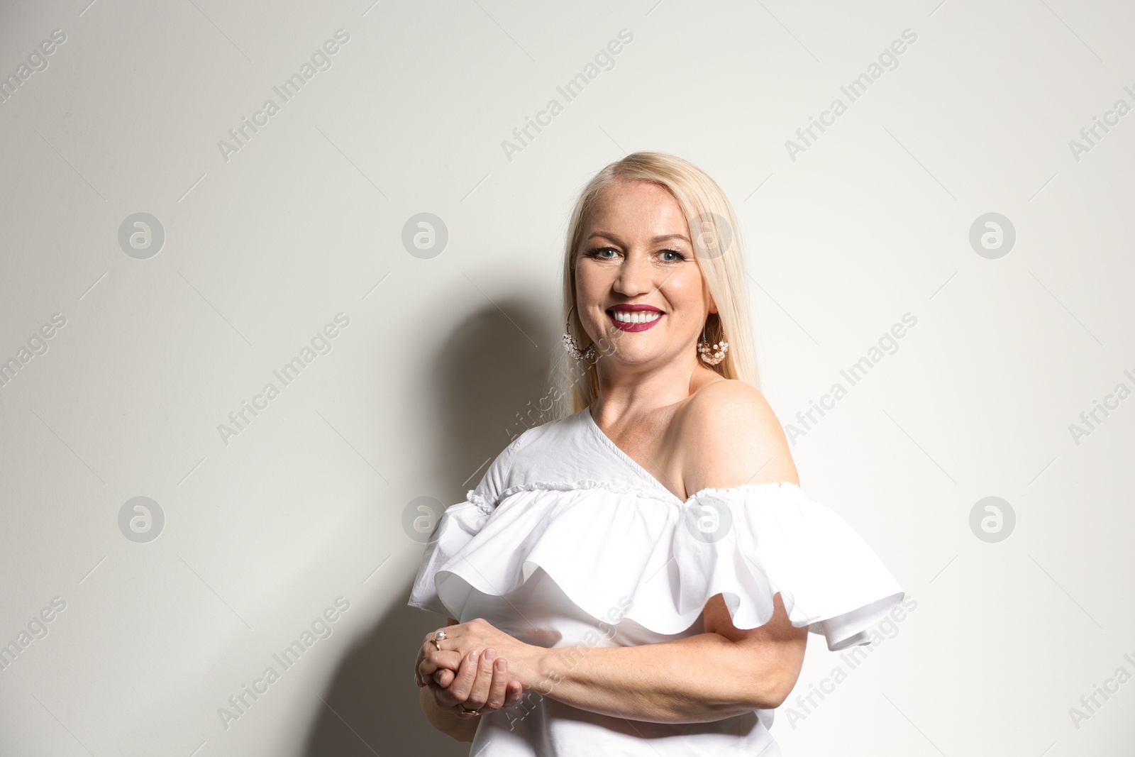 Photo of Portrait of beautiful mature woman on light background