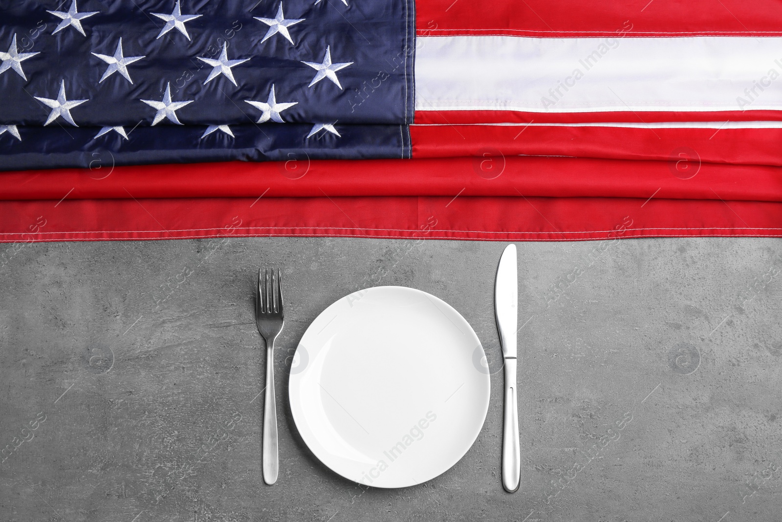 Photo of Patriotic table setting with USA flag on grey background, flat lay