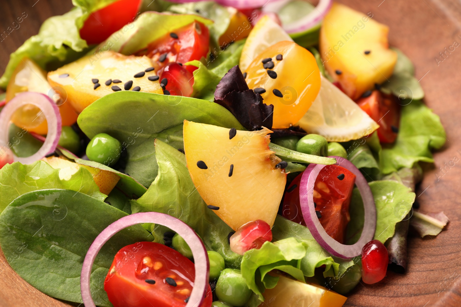 Photo of Delicious salad with peach, green peas and vegetables in bowl, closeup