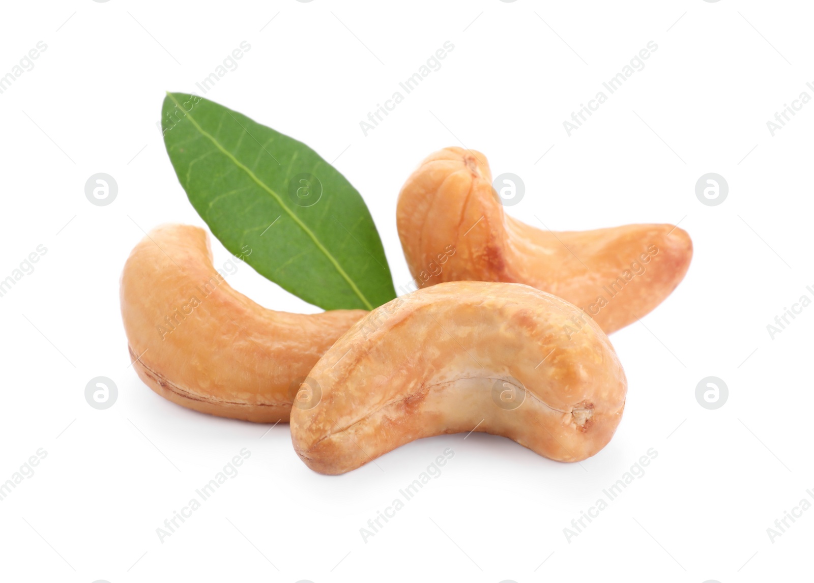 Photo of Tasty organic cashew nuts and green leaf isolated on white