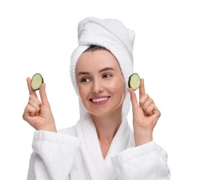 Photo of Beautiful woman in bathrobe with pieces of cucumber on white background