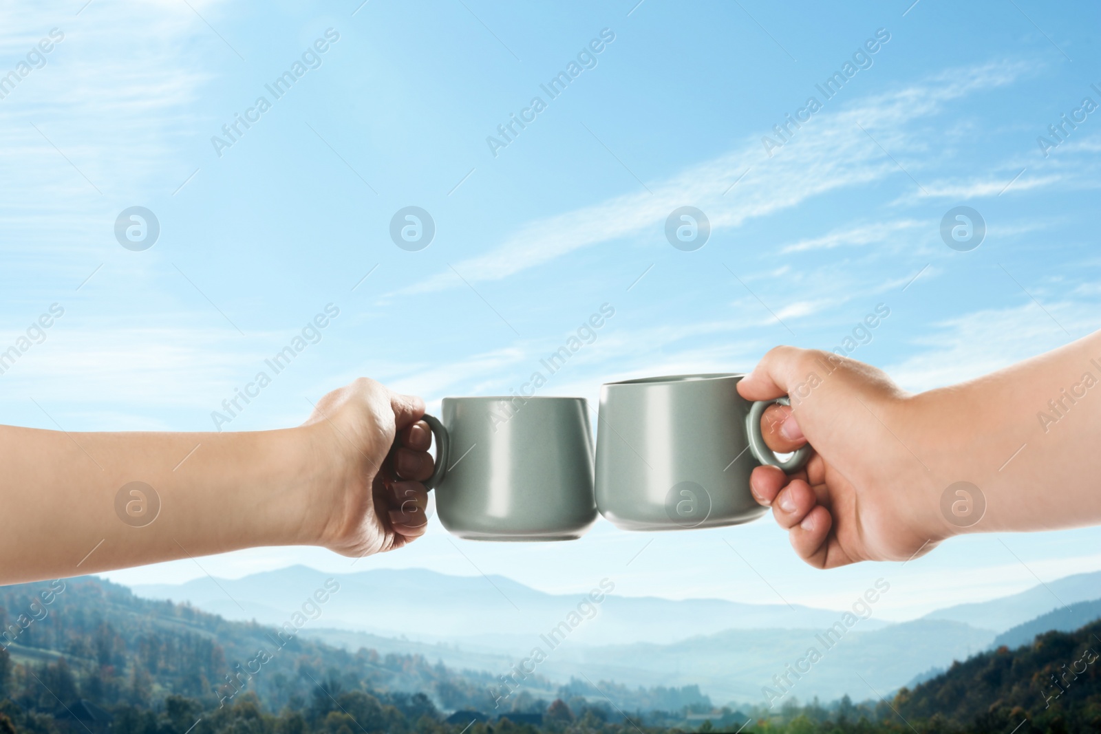 Image of Closeness to nature. Couple with cups in mountains, closeup