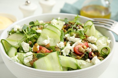 Delicious salad with lentils, vegetables and feta cheese served on table, closeup