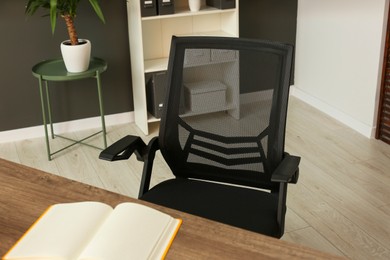 Stylish office chair at workplace in room. Interior design