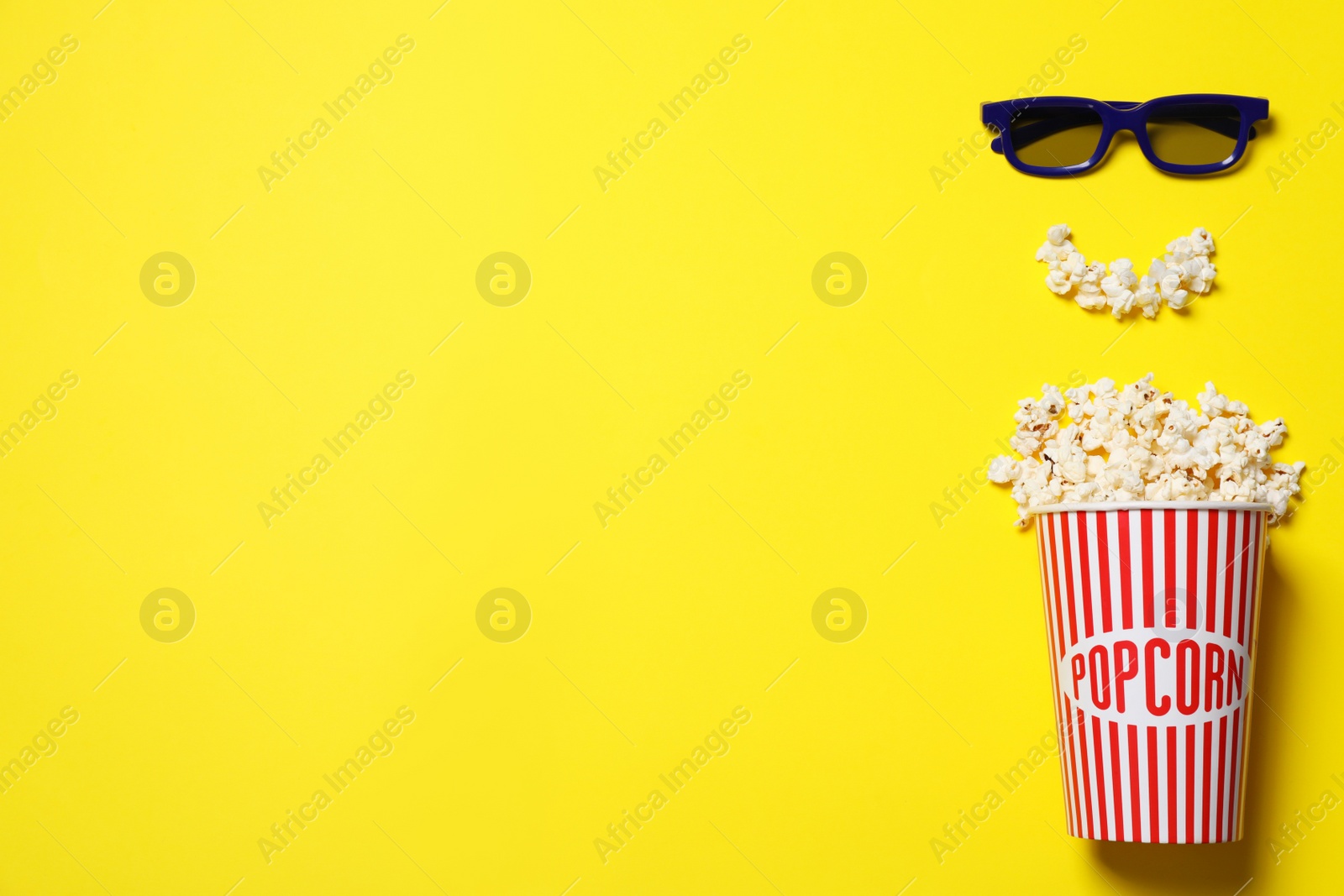 Photo of Popcorn and 3d glasses on yellow background, flat lay with space for text. Cinema snack