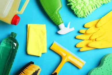 Photo of Flat lay composition with different car wash products on light blue background