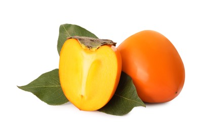 Whole and cut delicious ripe juicy persimmons on white background