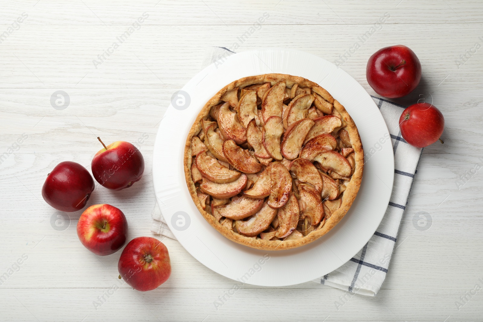 Photo of Delicious apple pie and fresh fruits on white wooden table, flat lay