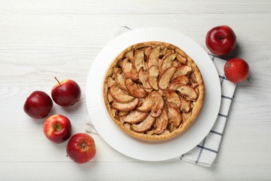 Photo of Delicious apple pie and fresh fruits on white wooden table, flat lay