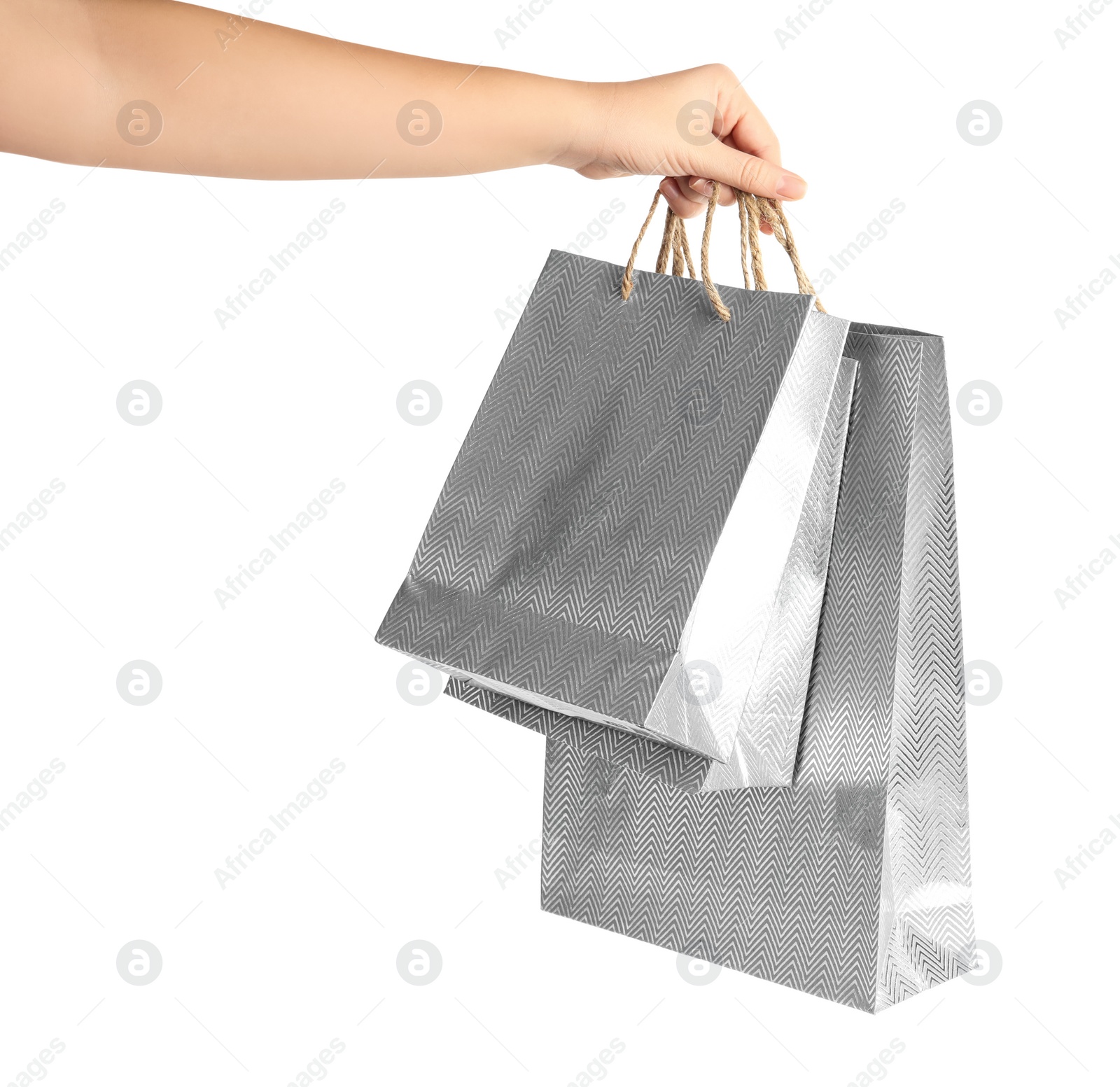 Photo of Woman holding paper shopping bags on white background, closeup. Space for design